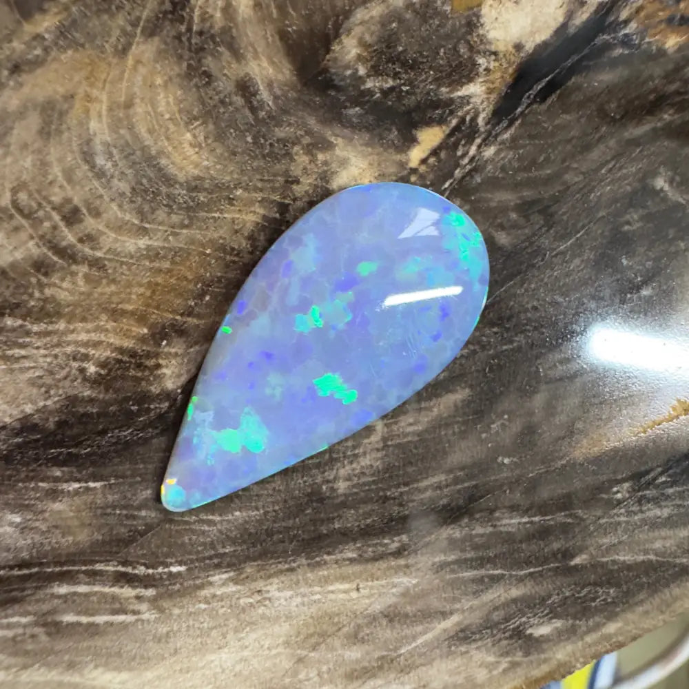 Teardrop-shaped opal with blue and green play-of-color.