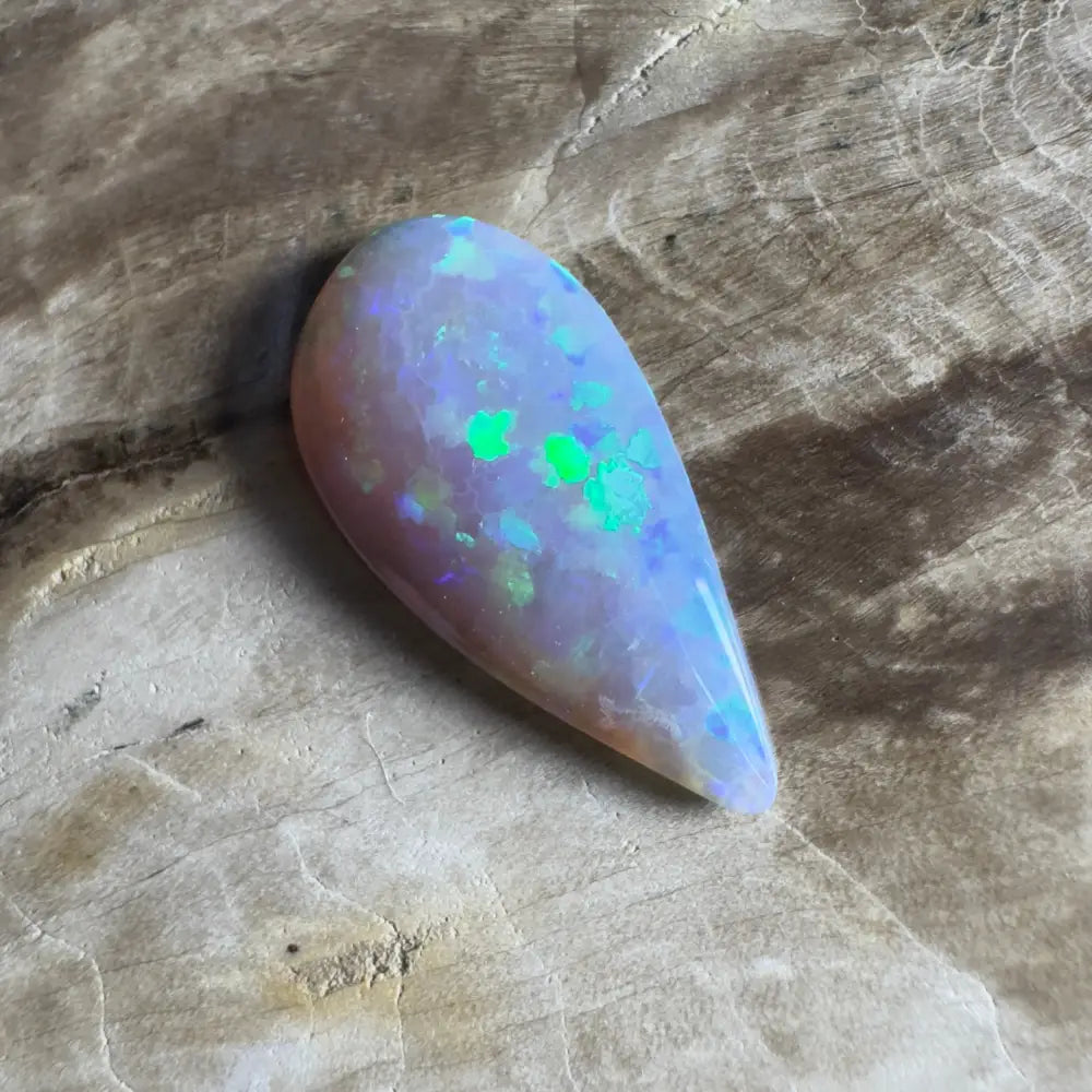 Teardrop-shaped opal with green and blue play-of-color.