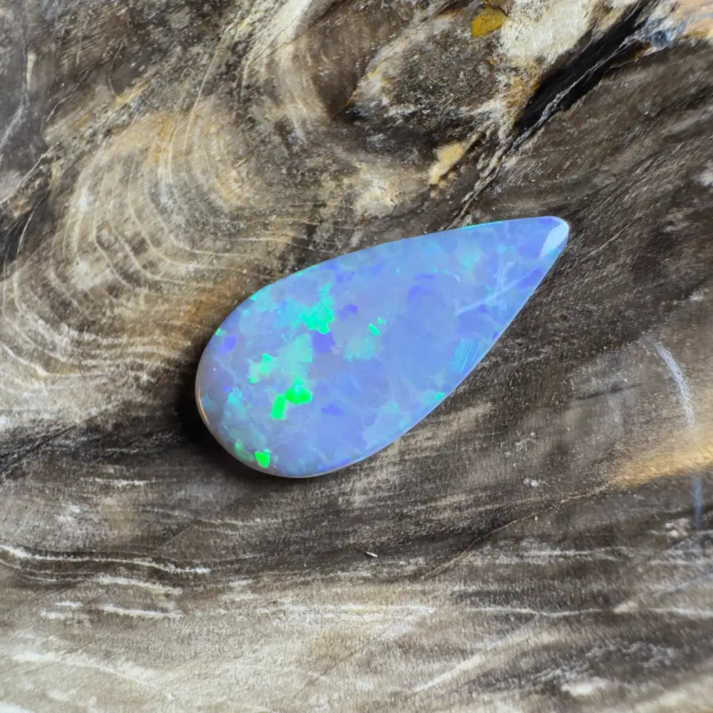 Teardrop-shaped opal with blue and green play-of-color.