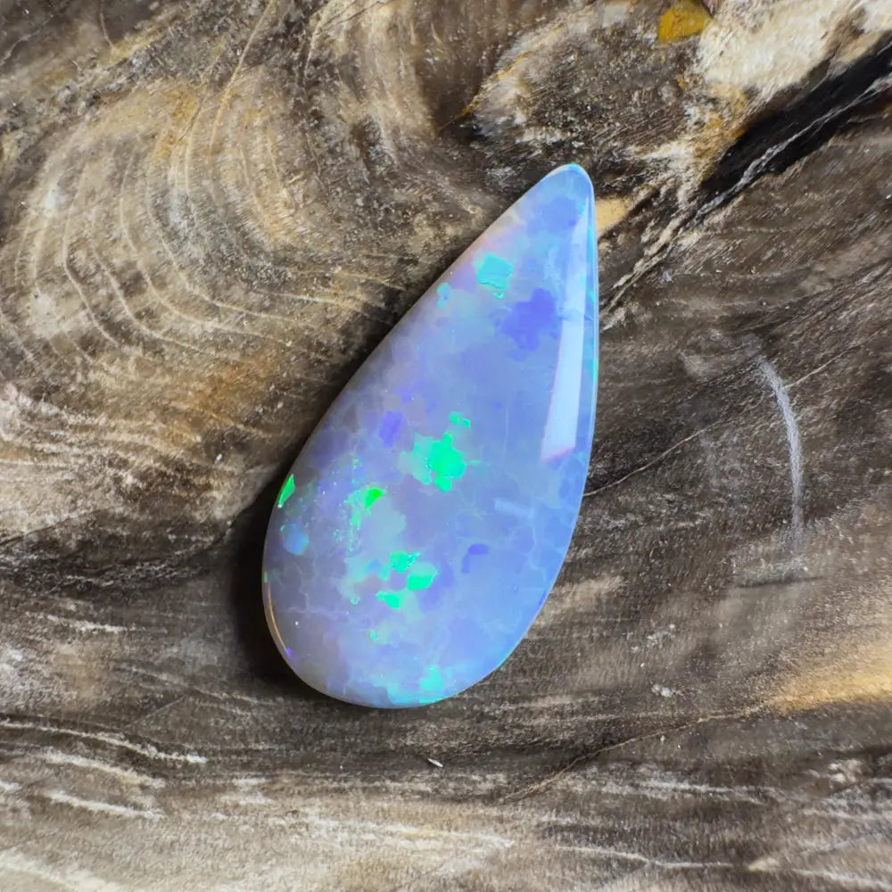 Teardrop-shaped opal with blue and green play-of-color.
