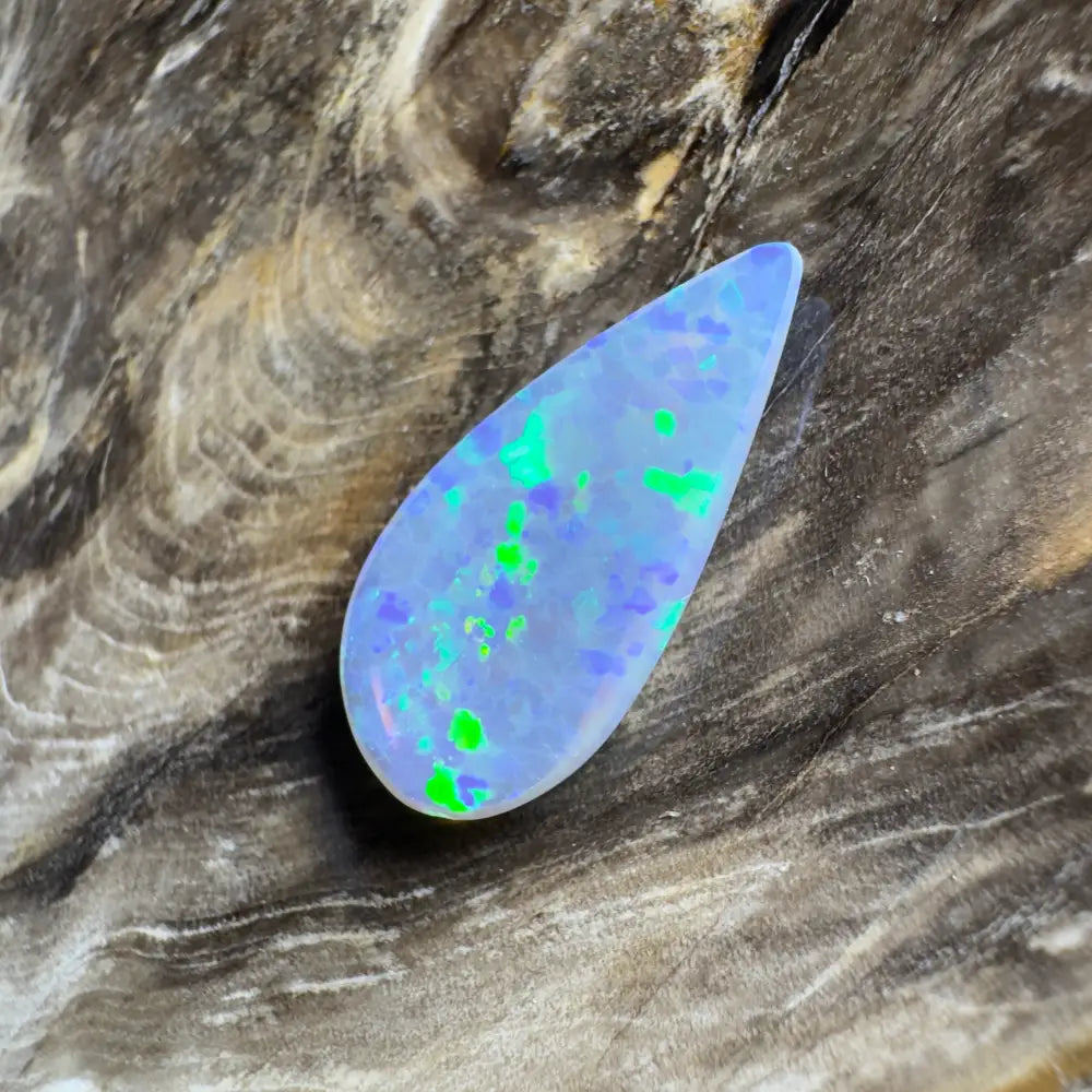 Teardrop-shaped opal with blue, green, and purple play-of-color.