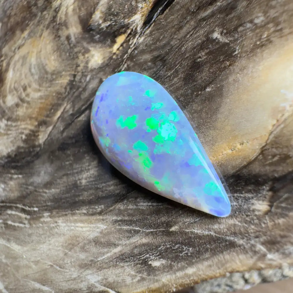 Teardrop-shaped opal with blue and green play-of-color.