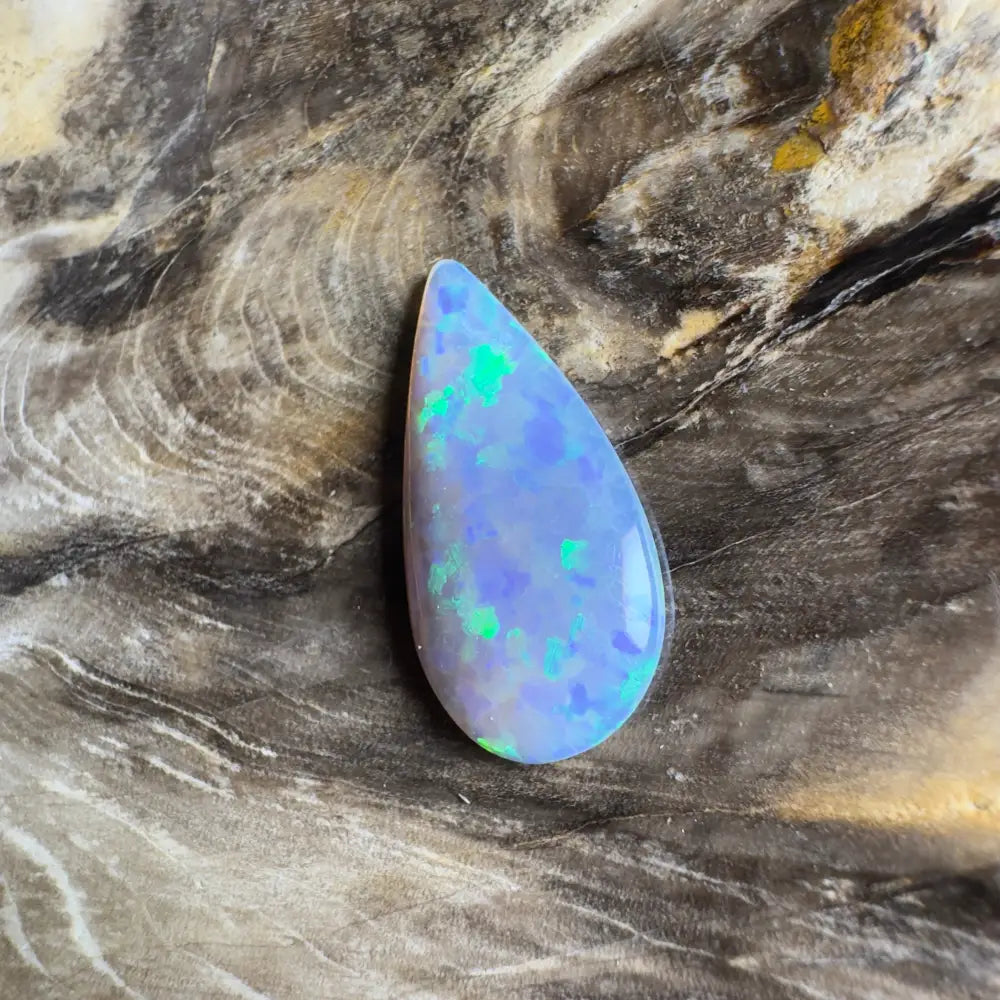 Teardrop-shaped opal with blue and green play-of-color.