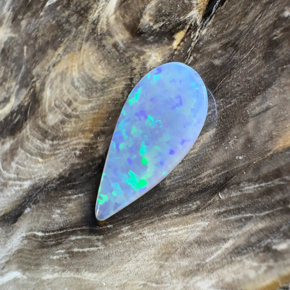 Teardrop-shaped opal with blue and green play-of-color.