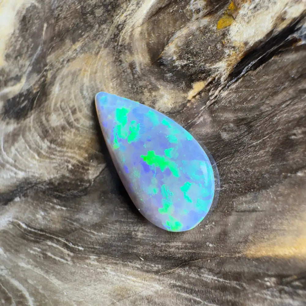 Teardrop-shaped opal with blue and green play-of-color.