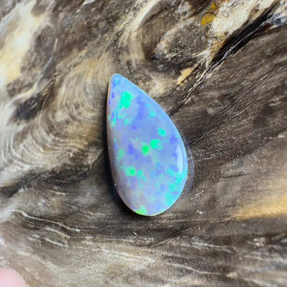 Teardrop-shaped opal with blue and green play-of-color.
