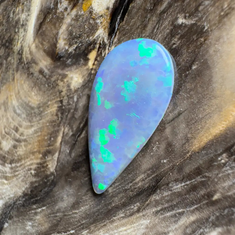 Teardrop-shaped opal with blue and green play-of-color.