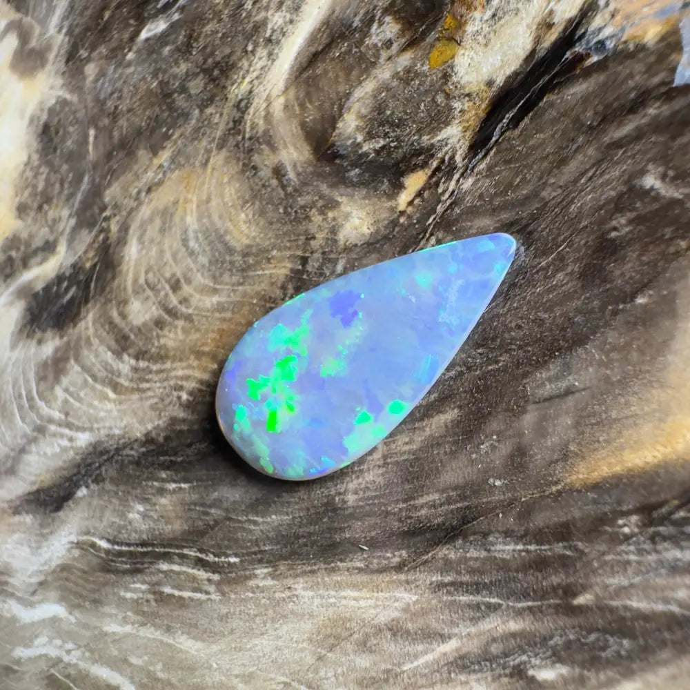 Teardrop-shaped opal with blue and green play-of-color.