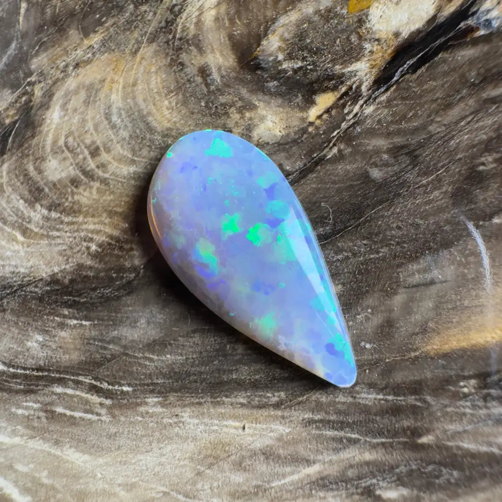 Teardrop-shaped opal with blue and green play-of-color.