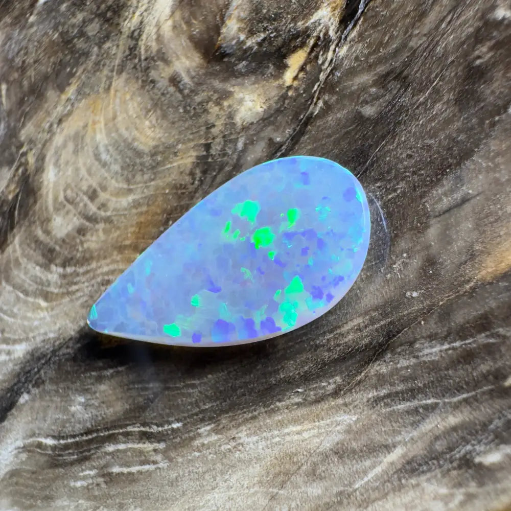 Teardrop-shaped opal with blue and green flashes.