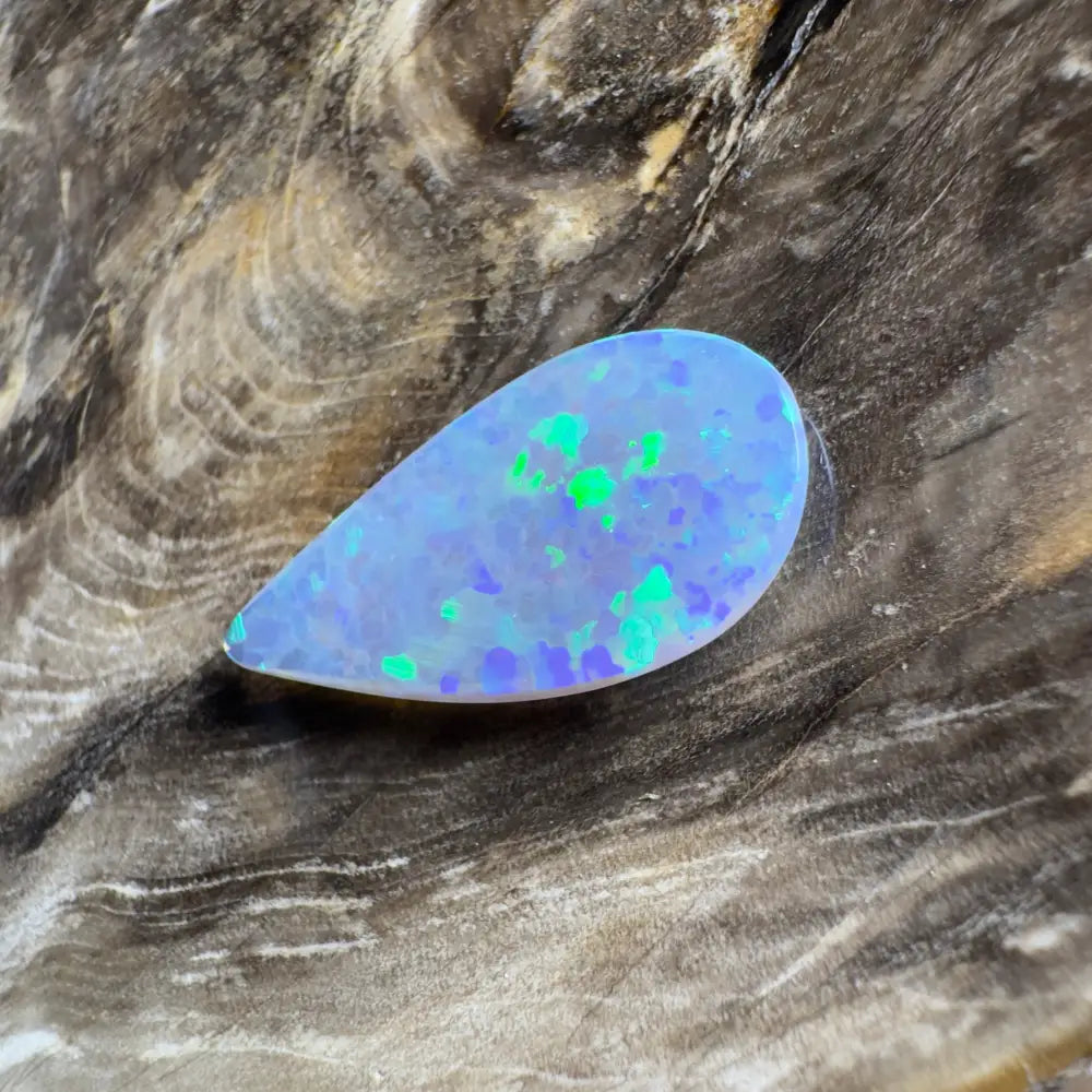 Teardrop-shaped opal with blue and green play-of-color.
