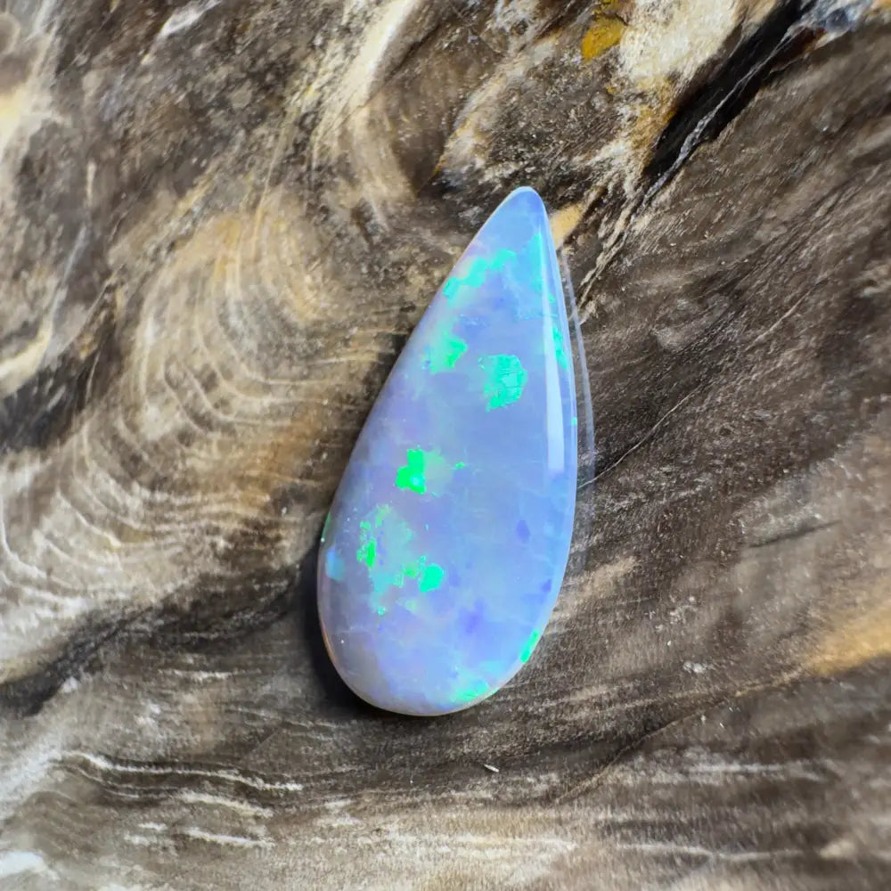 Teardrop-shaped opal with green and blue play-of-color.