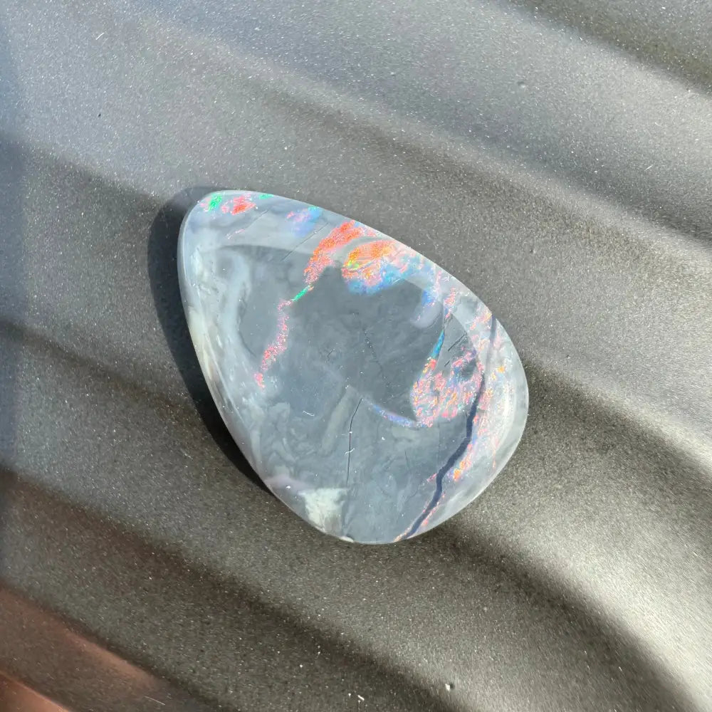 Iridescent polished opal cabochon from 5.7 carat Hand-Cut Solid Lightning Ridge Semi Black Opal