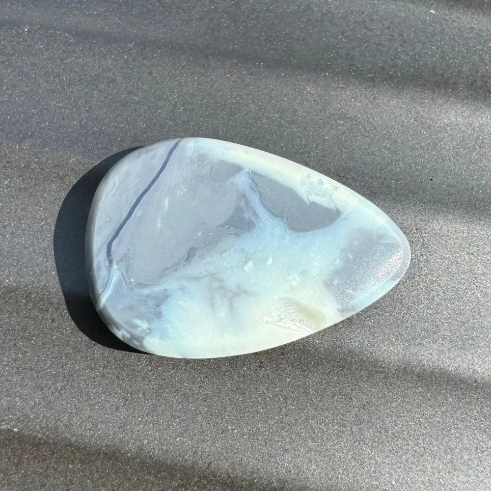 Polished blue and white stone in 5.7 carat Hand-Cut Solid Lightning Ridge Semi Black Opal