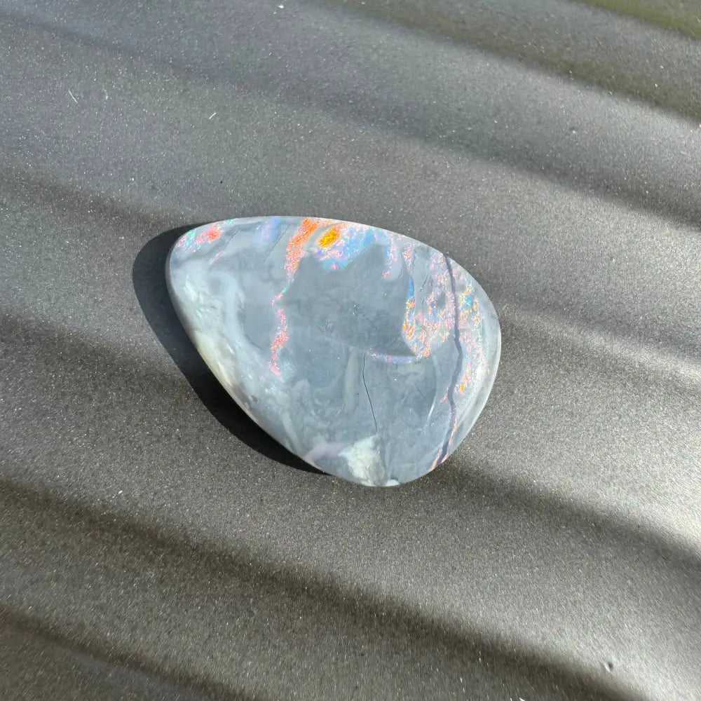 Polished multicolored Lightning Ridge semi-black opal cabochon for jewelry design