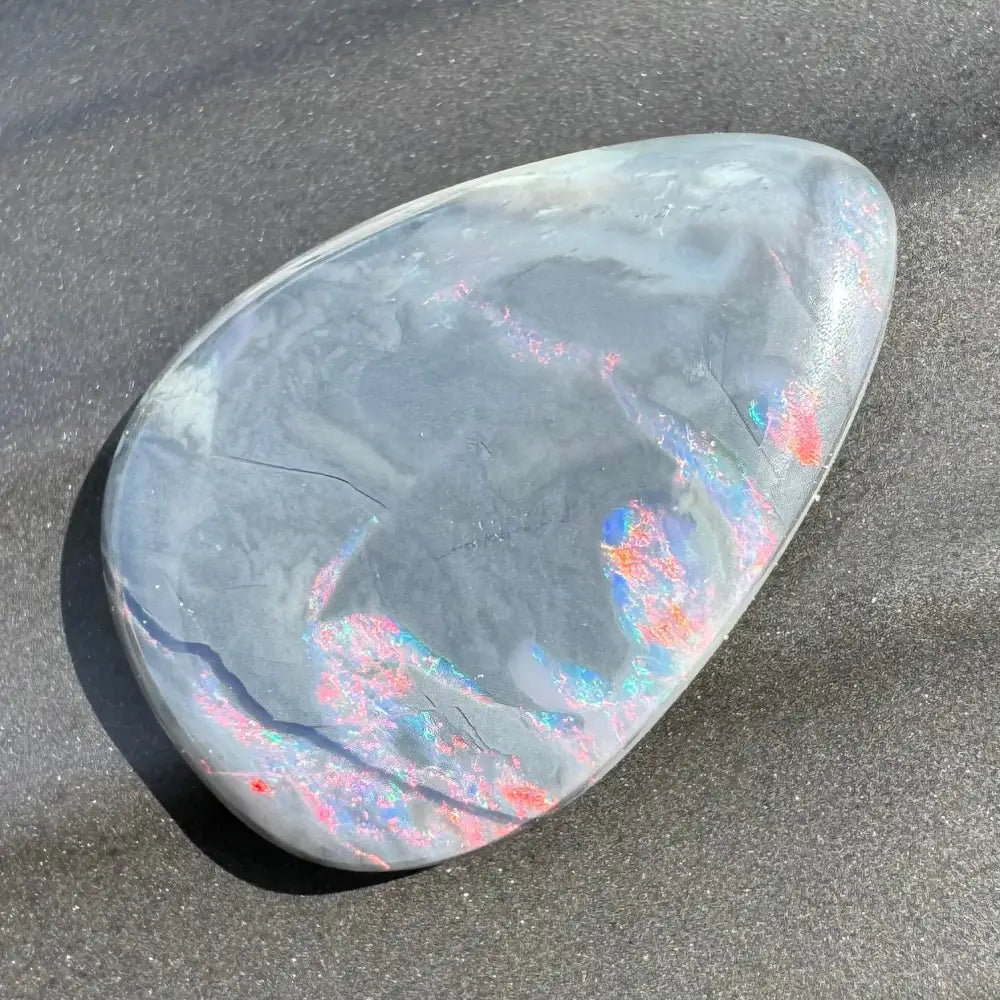 Polished gray Lightning Ridge semi-black opal with iridescent flashes in a 5.7 carat hand-cut gem
