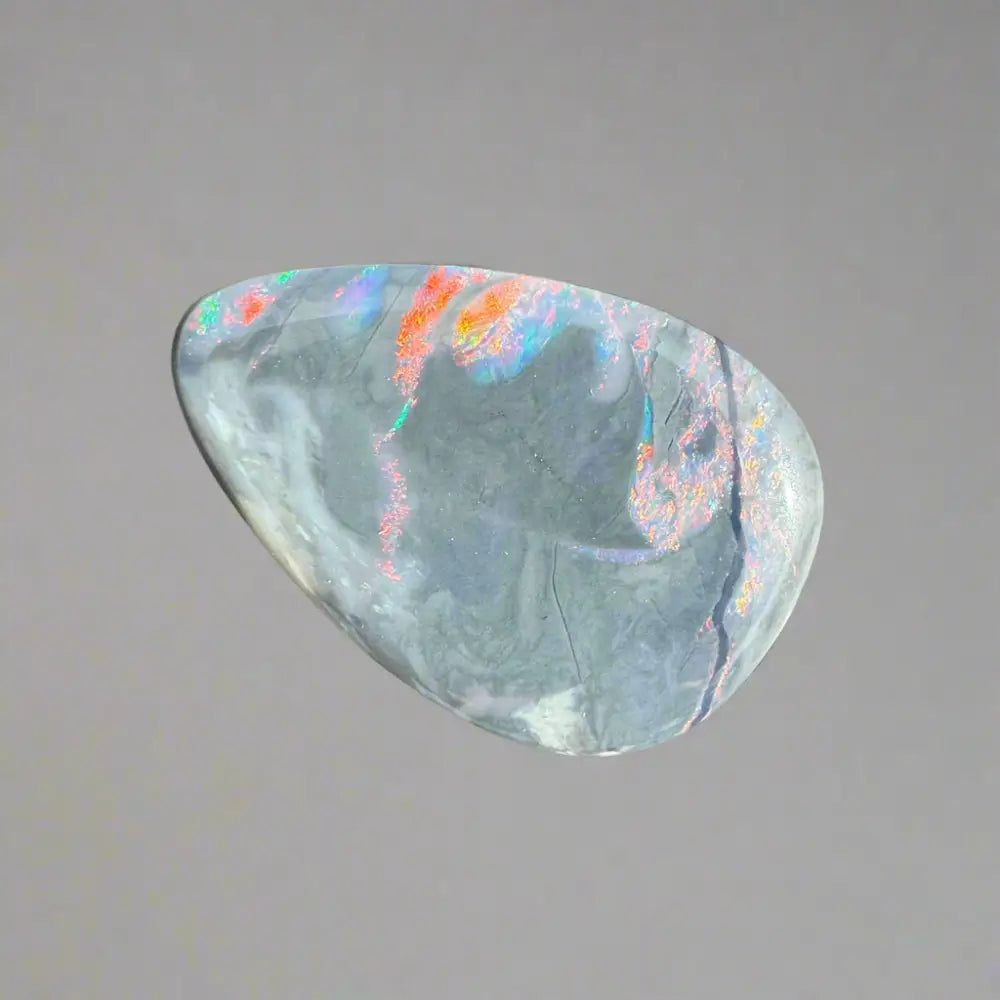 Iridescent opal gemstone from Lightning Ridge in the 5.7 carat hand-cut solid semi black opal product