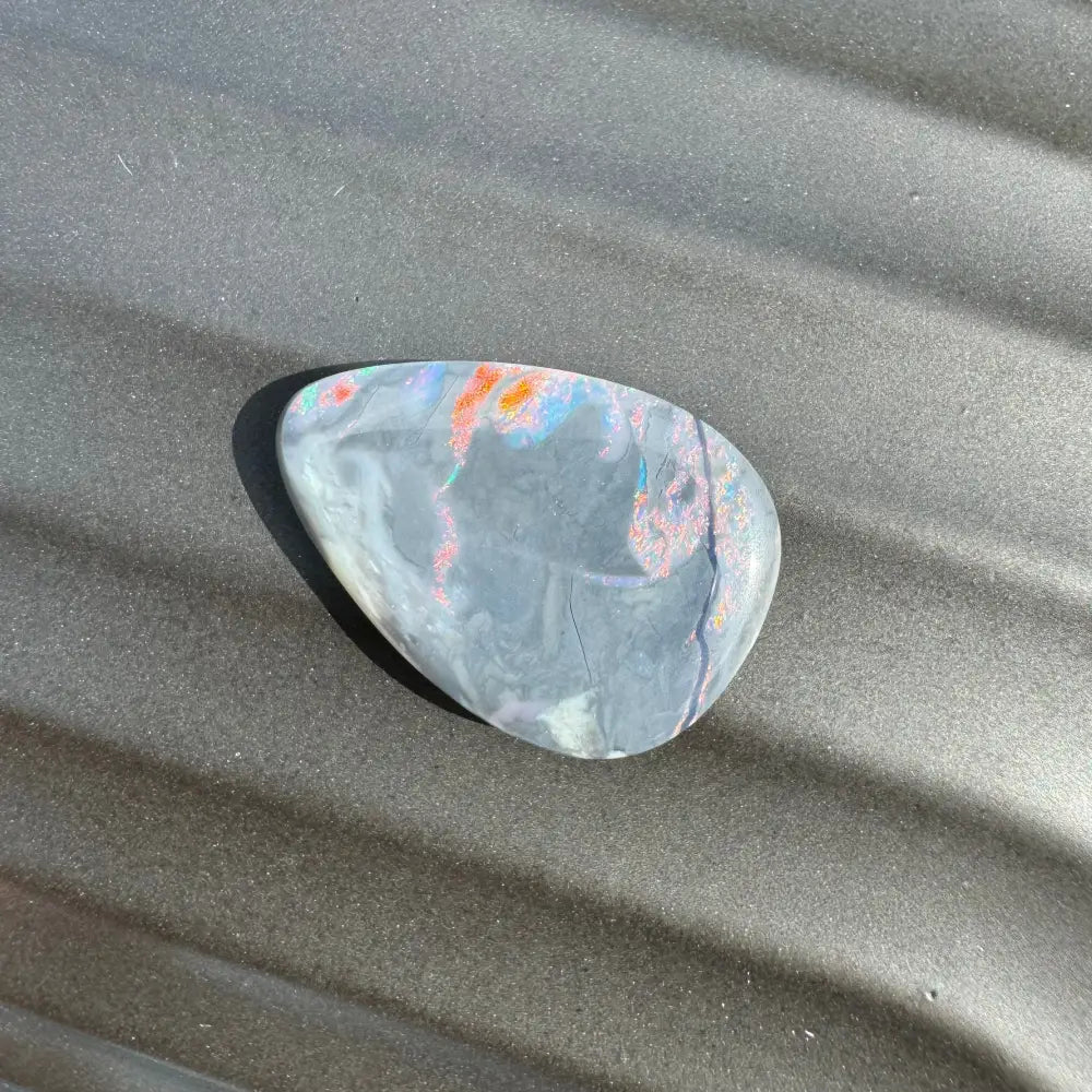 Irregularly shaped Lightning Ridge semi black opal with colorful inclusions for jewelry