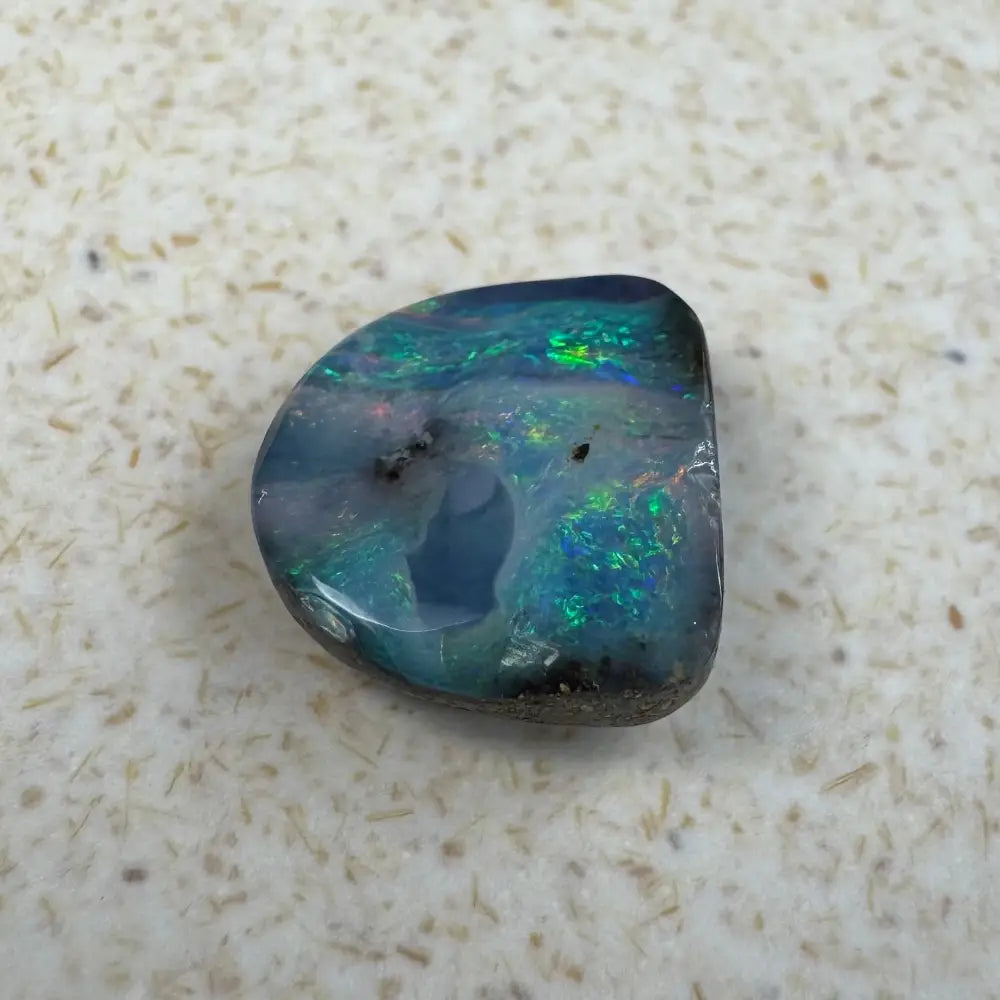 Iridescent Queensland Boulder Opal gemstone displayed in 5.9 carat hand-cut jewelry