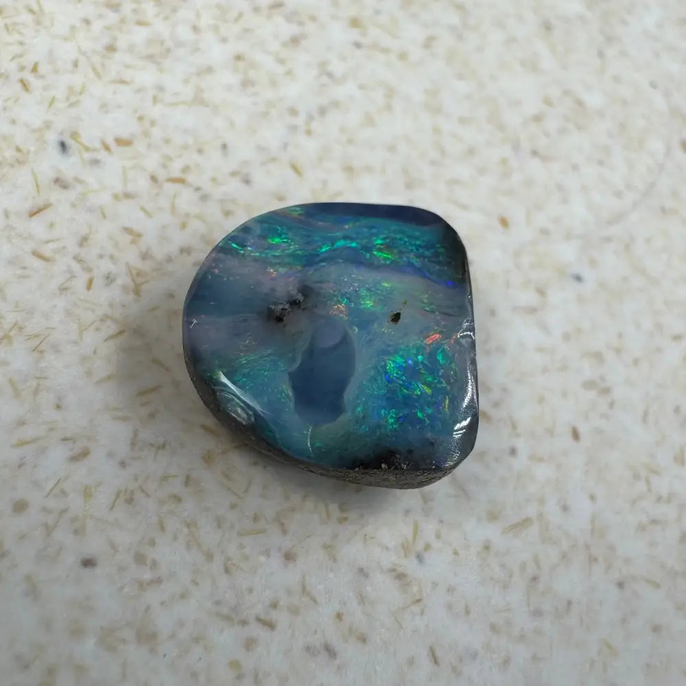 Iridescent blue-green Queensland Boulder Opal cabochon in a 5.9ct hand-cut display