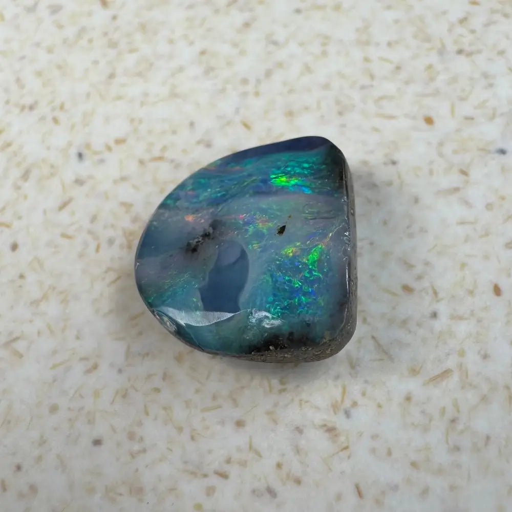 Iridescent Queensland Boulder Opal gemstone in a 5.9ct hand-cut jewelry display