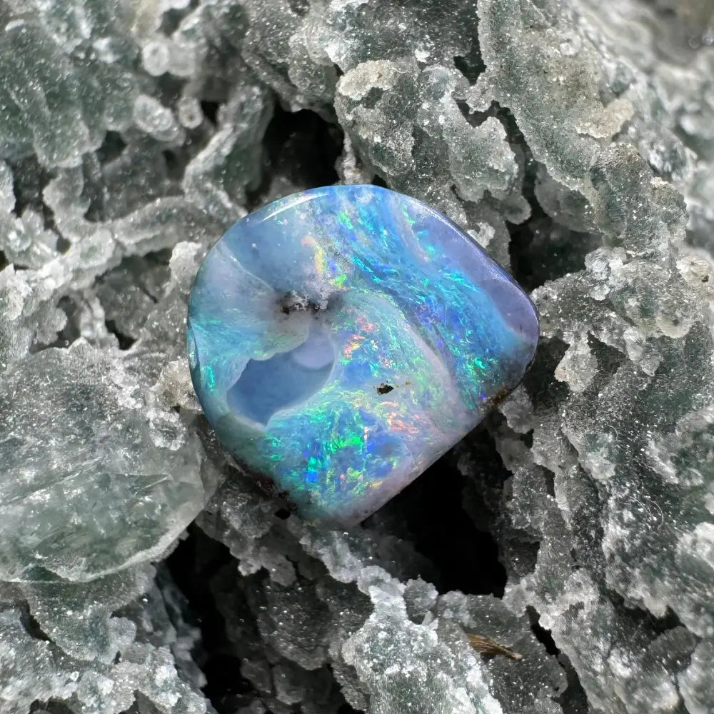 Iridescent blue Queensland Boulder Opal gemstone showcasing vibrant play of color