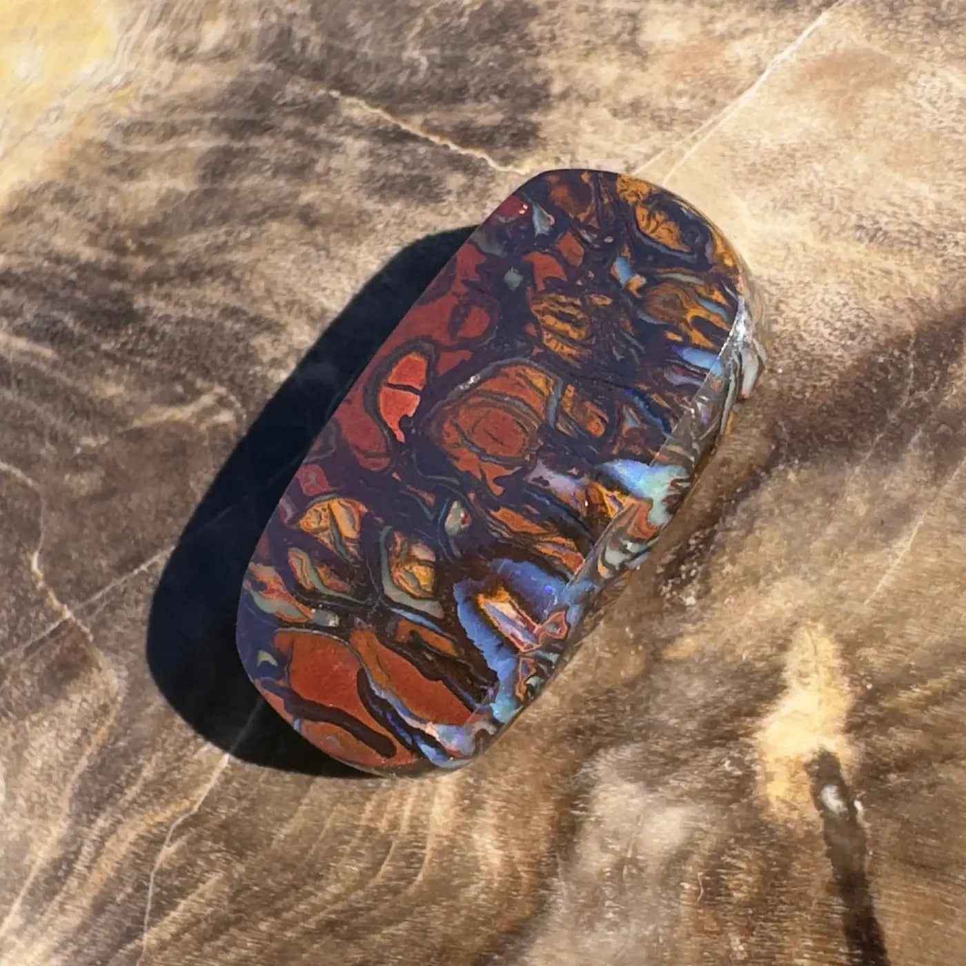 Polished Boulder Opal with vibrant color play in 8.3ct hand-cut solid boulder opal