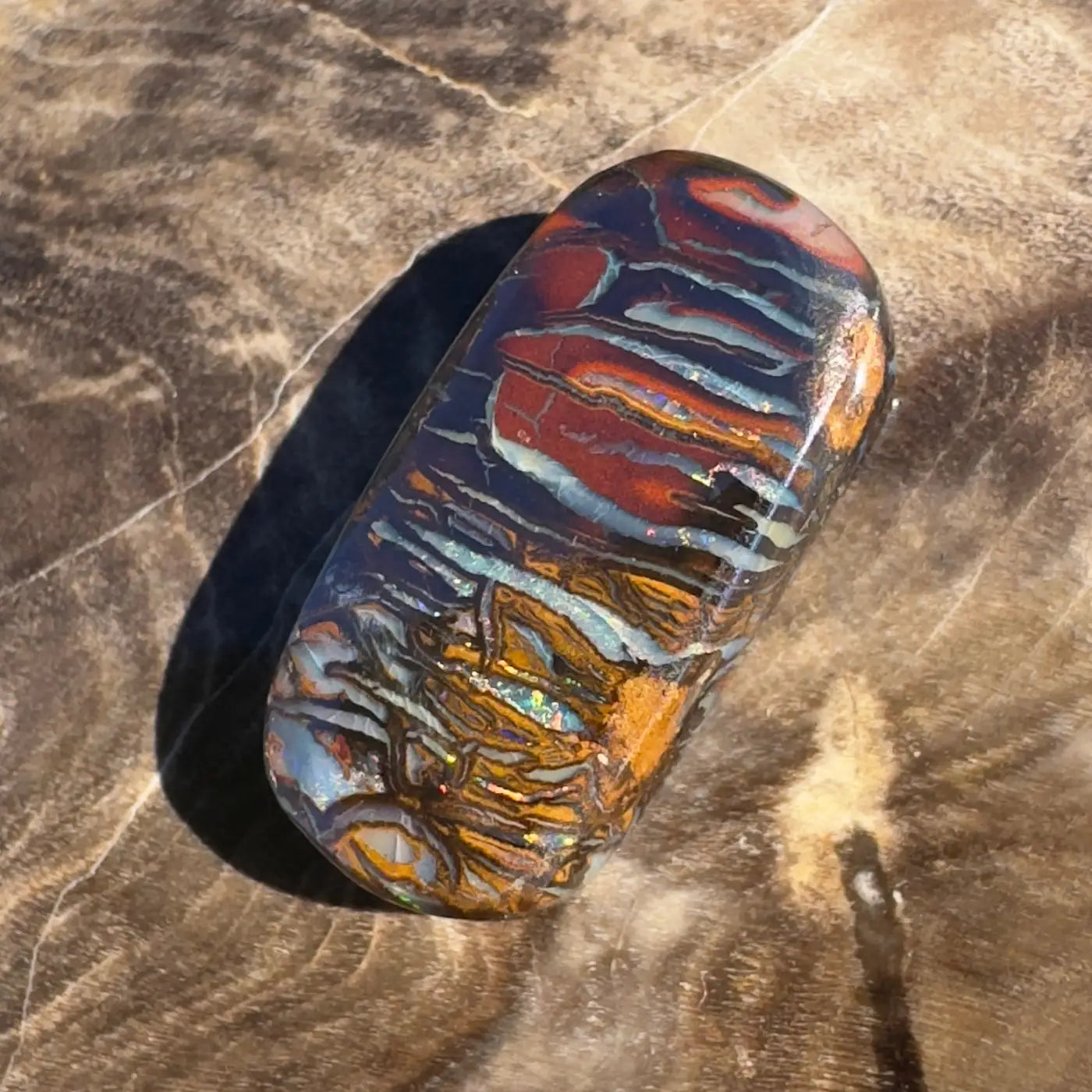 Polished Boulder Opal with vibrant color play for the 8.3ct Hand-Cut Solid Boulder Opal product