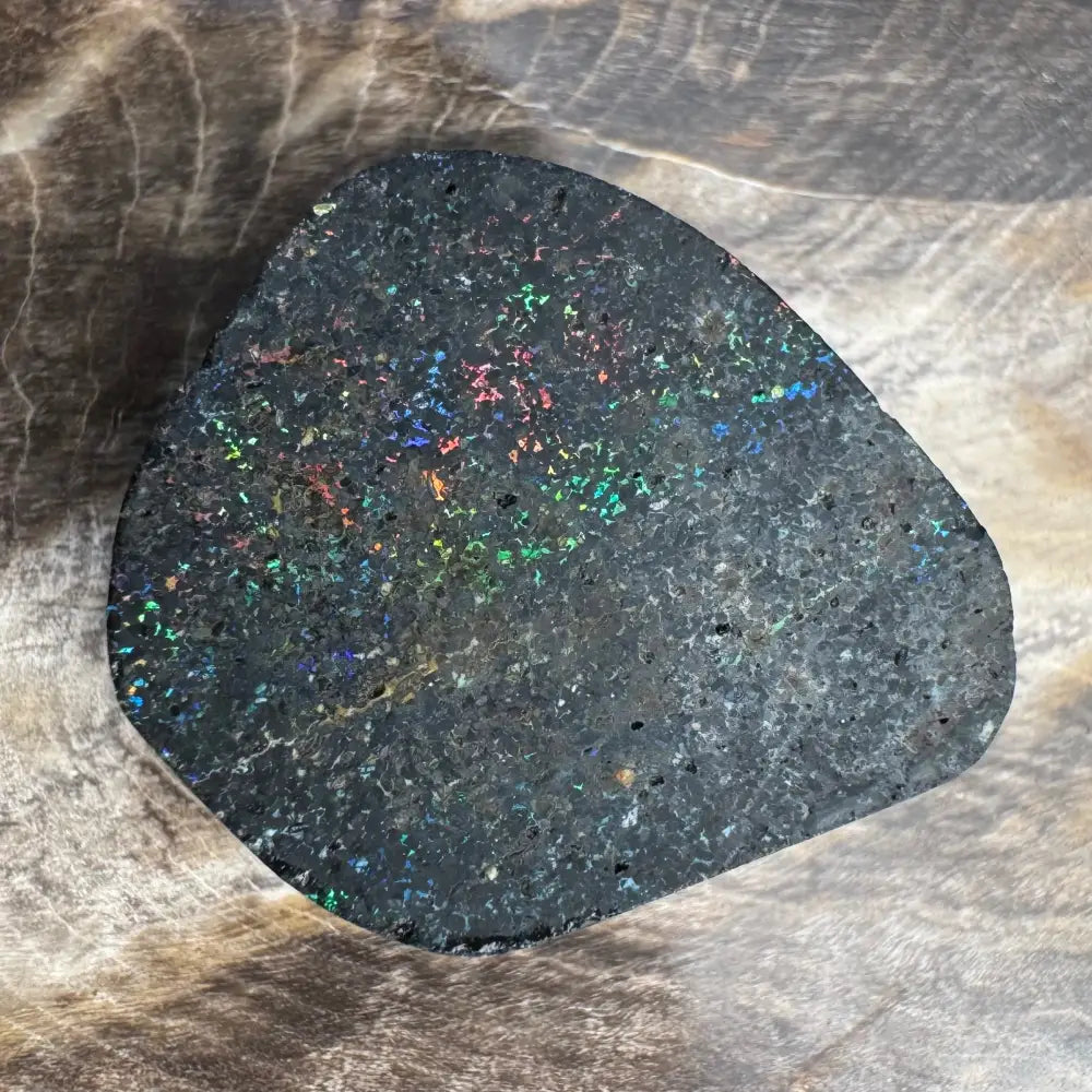 Irregularly shaped black opal with colorful specks in the Andamooka Matrix Opal 22carat solid hand-cut
