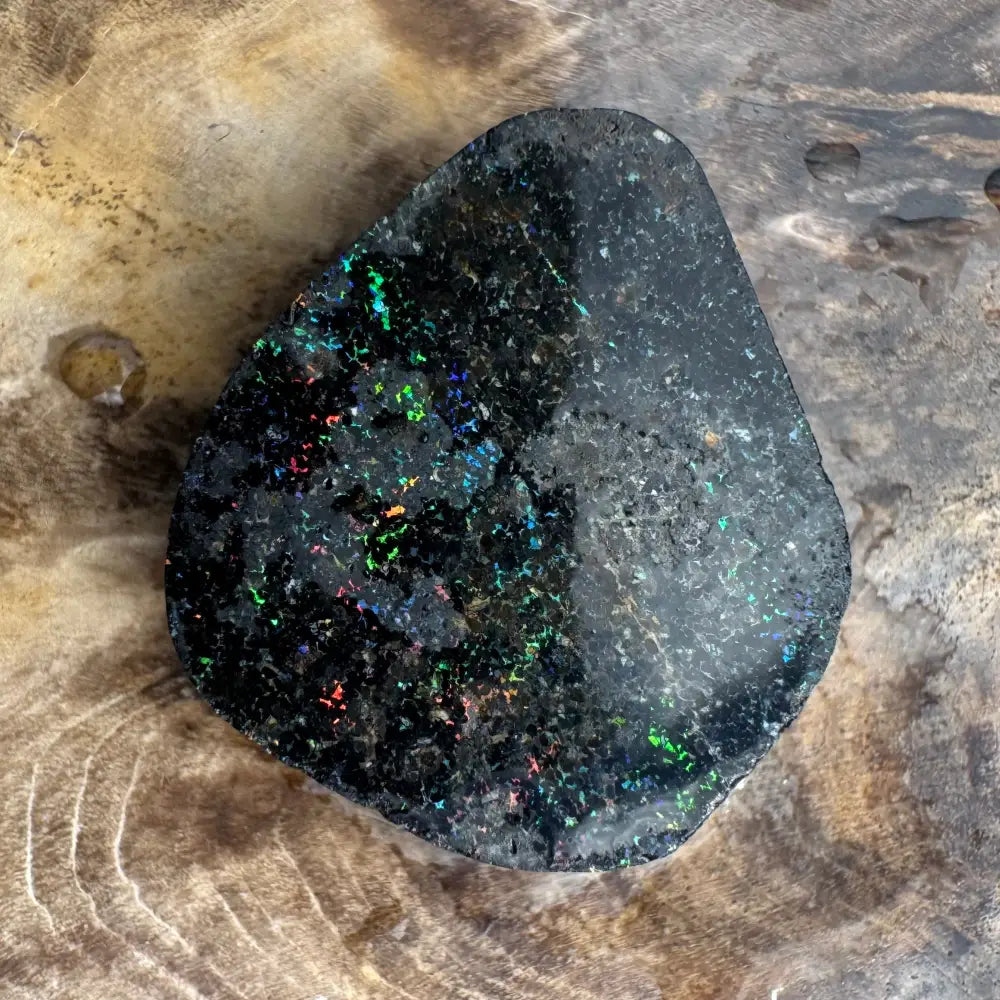 Polished black opal with iridescent flashes in the Andamooka Matrix Opal 22carat solid hand-cut