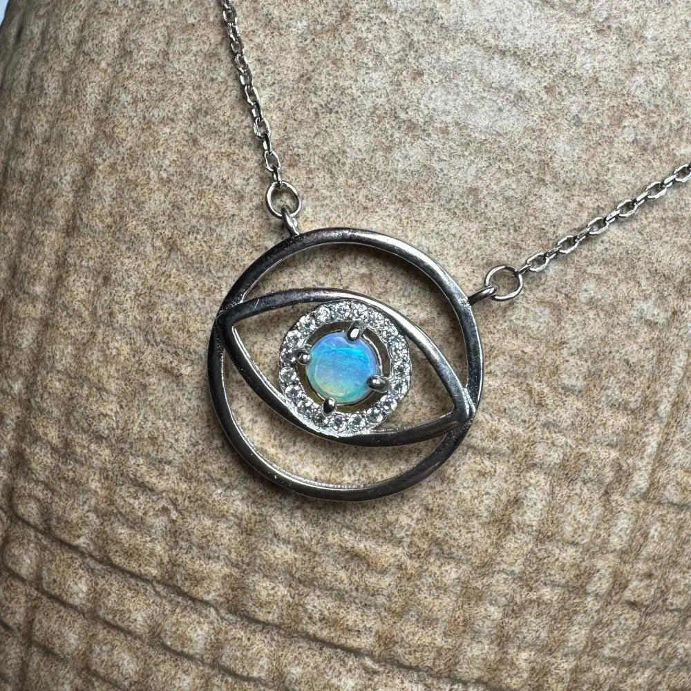 Silver eye pendant necklace with a luminous opal center from Lightning Ridge