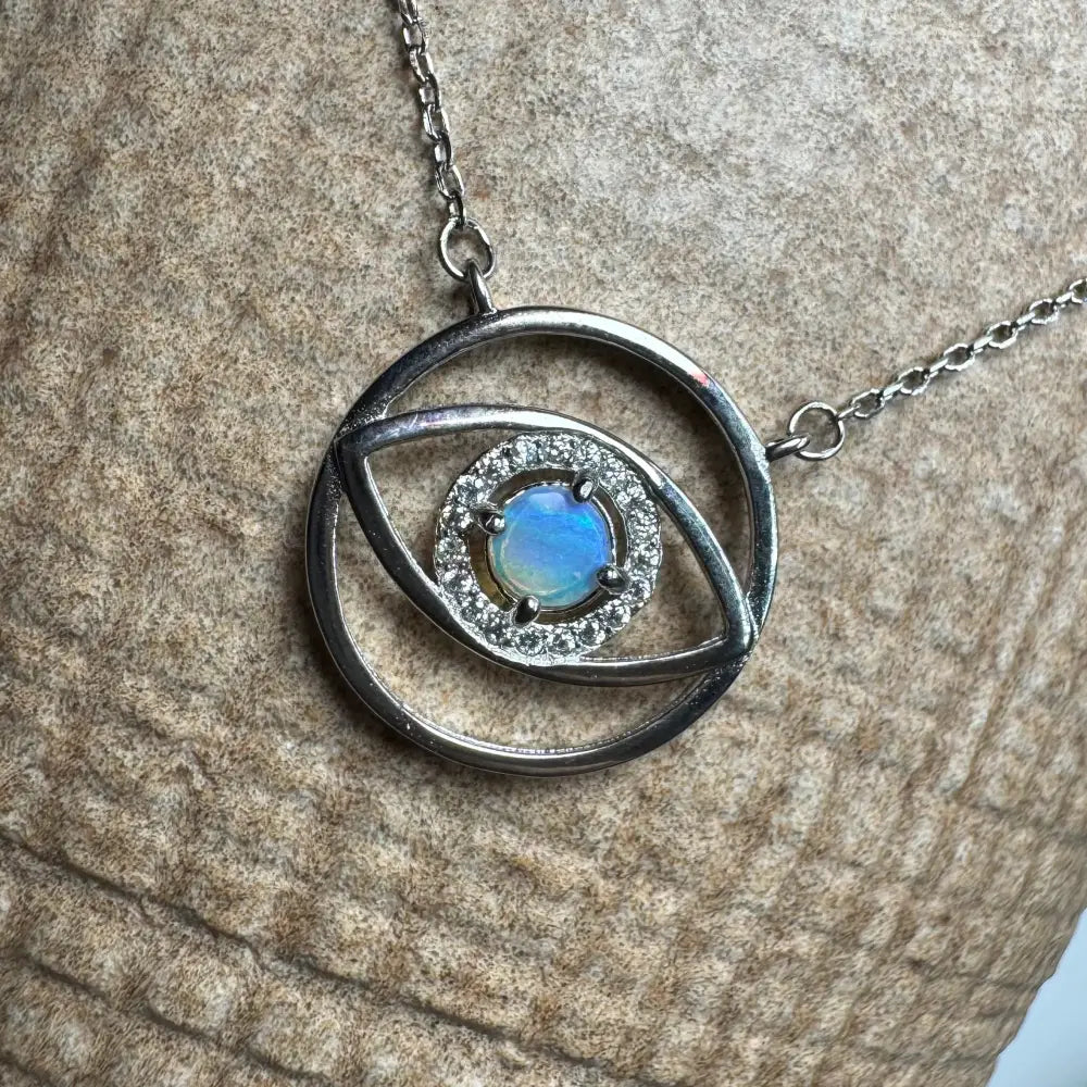 Silver eye-shaped pendant necklace with a luminous opal center from Lightning Ridge