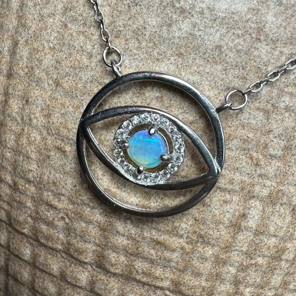 Silver eye pendant necklace featuring a 0.3ct Lightning Ridge Opal center in sterling silver