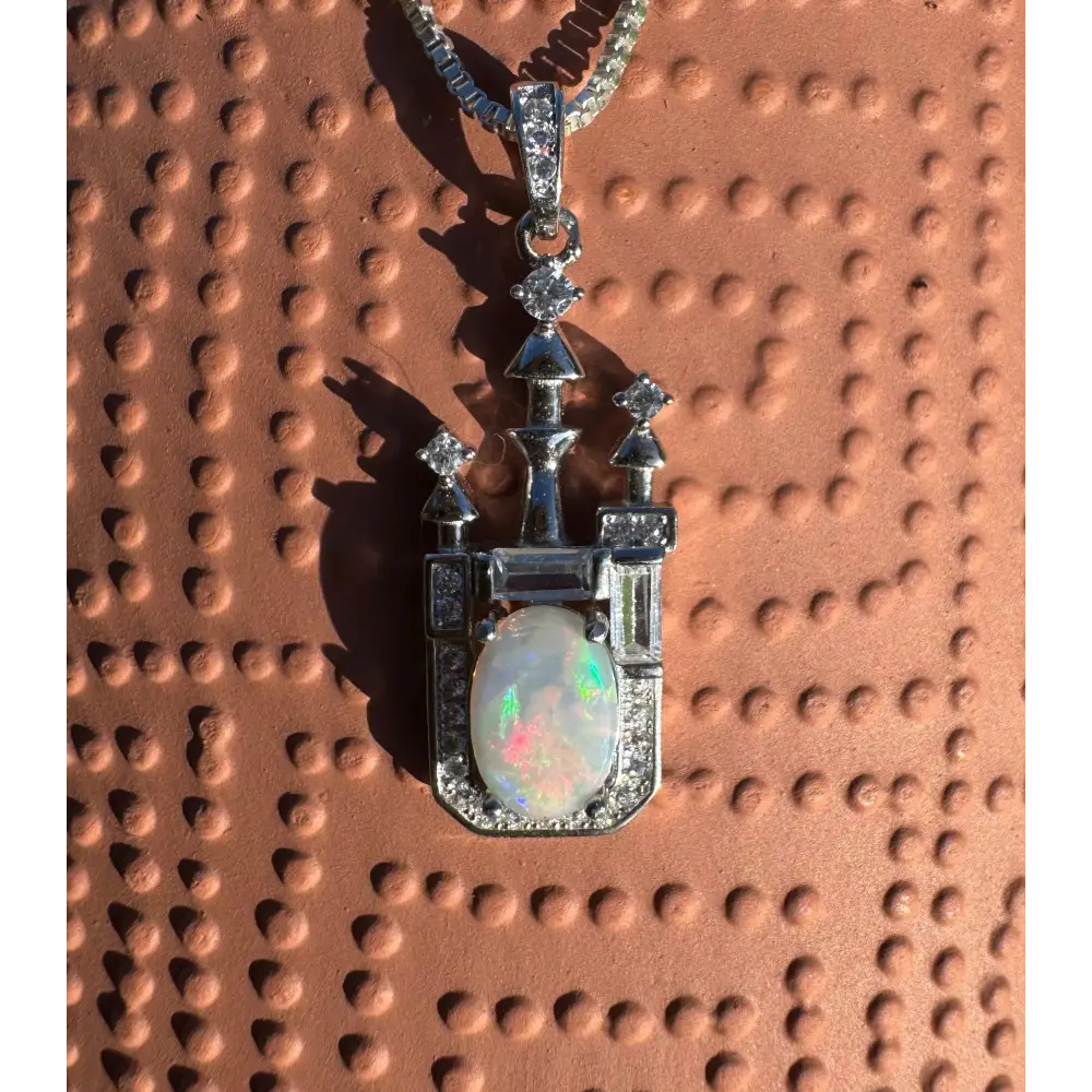 Castle-shaped opal pendant necklace featuring handcrafted Lightning Ridge opal and cubic zirconia in sterling silver