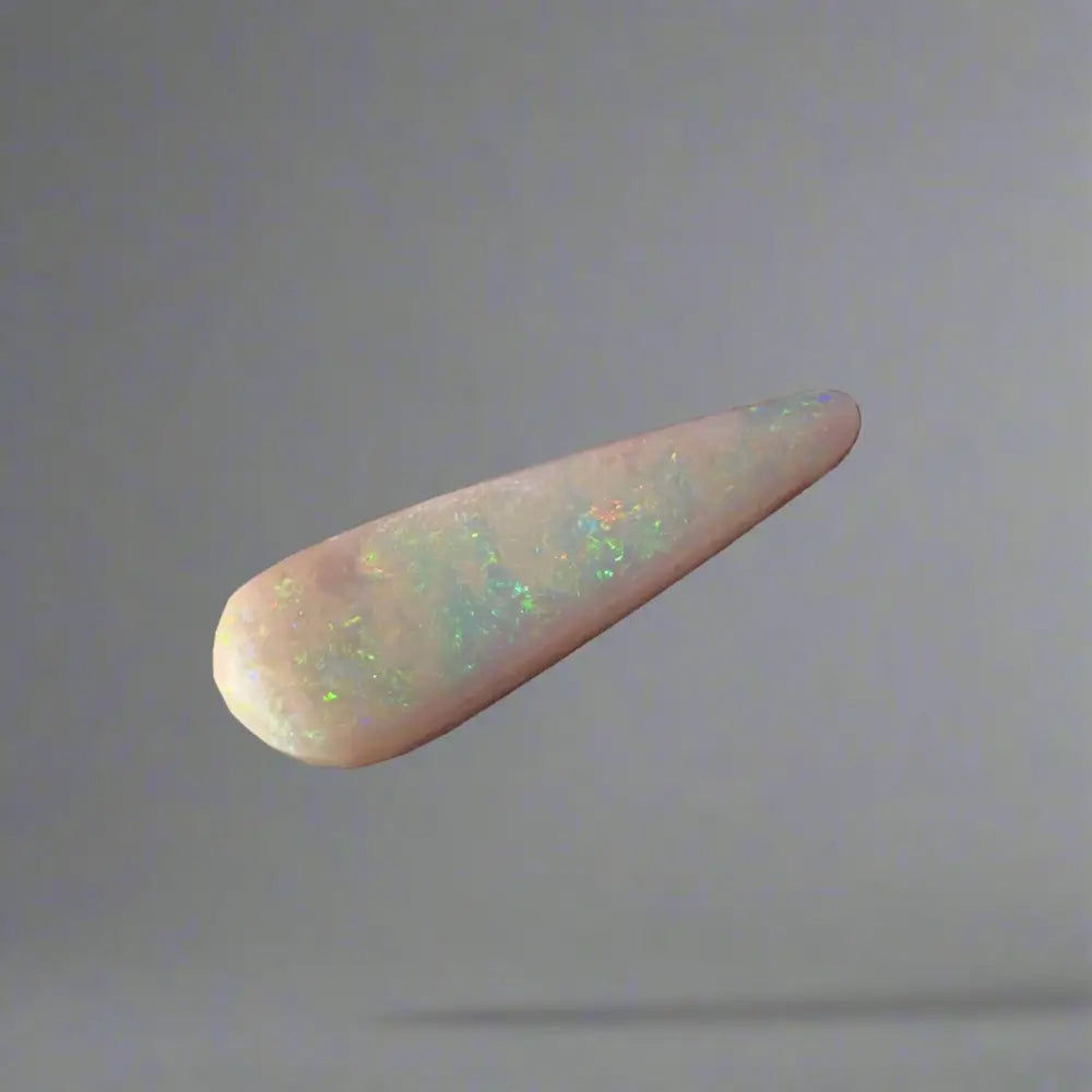 Elongated Coober Pedy Opal gemstone displaying vibrant play of colors in a 2.6carat solid hand-cut piece