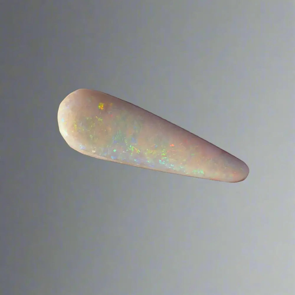 Elongated Coober Pedy opal gemstone with iridescent flashes in a 2.6carat solid hand-cut form