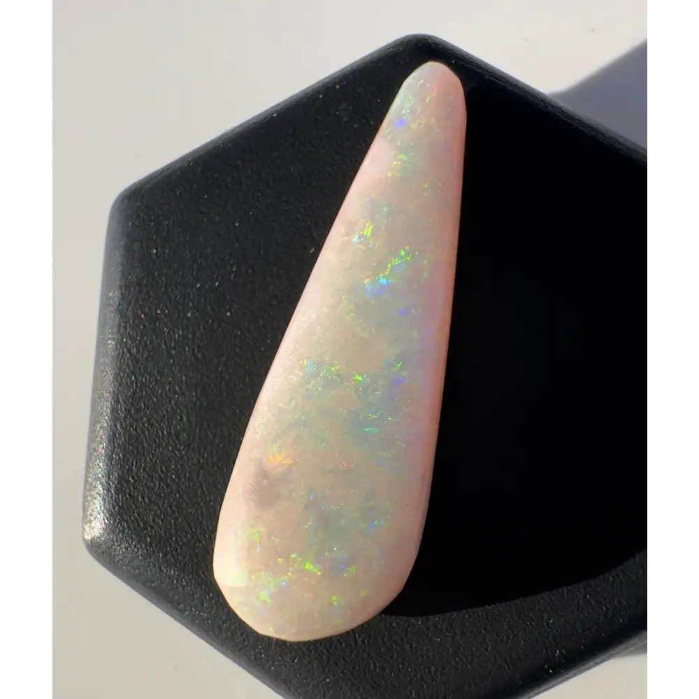 Iridescent white opal gemstone from Coober Pedy weighing 2.6 carats and hand-cut