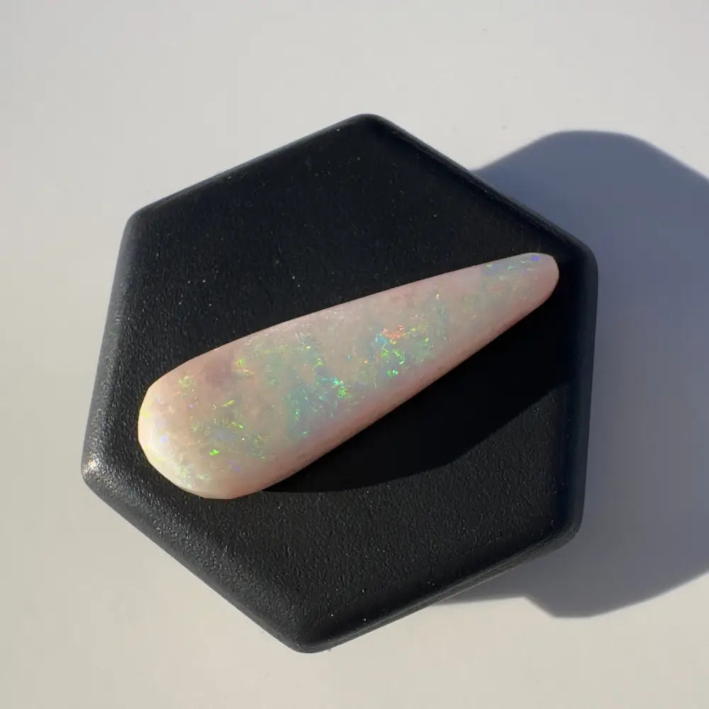 Elongated Coober Pedy Opal cabochon with iridescent play-of-color in a 2.6 carat solid hand-cut gemstone