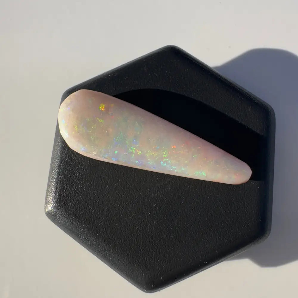 Iridescent elongated opal gemstone from Coober Pedy weighing 2.6 carats
