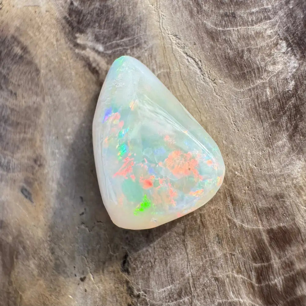 Polished Coober Pedy Opal gemstone with iridescent flashes in a 3.3carat solid hand-cut style