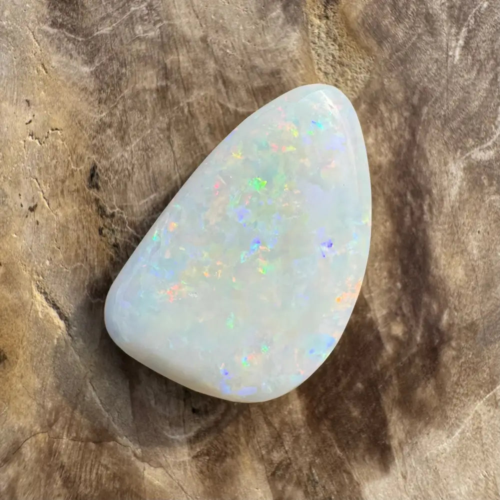 Iridescent white opal gemstone from Coober Pedy weighing 8.4 carats, hand-cut solid piece