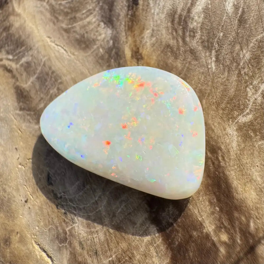 Iridescent white opal cabochon from Coober Pedy displayed in a 8.4 carat solid hand-cut setting