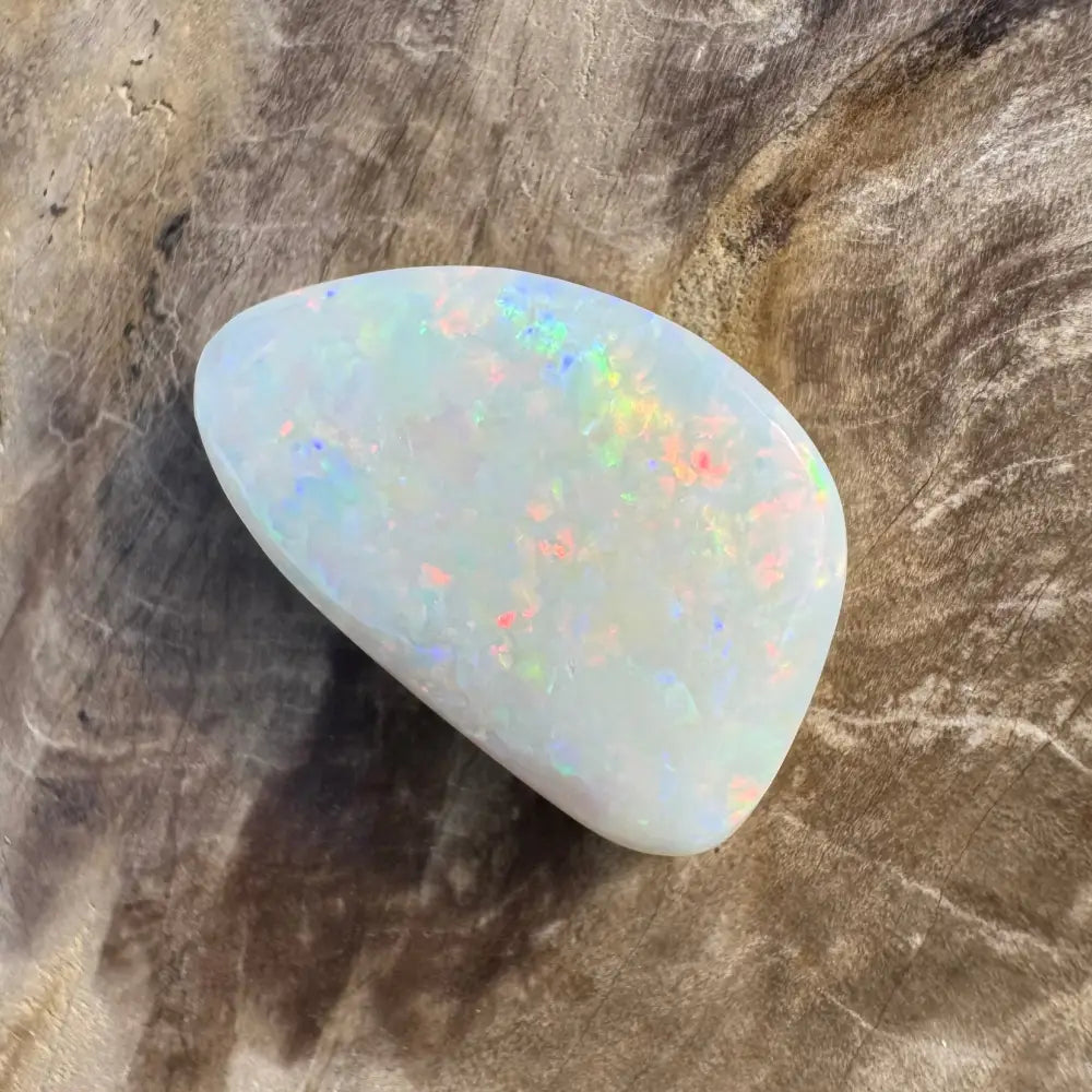 Iridescent white opal gemstone showcasing vibrant play-of-color on a Coober Pedy Opal 8.4 carats solid hand-cut product