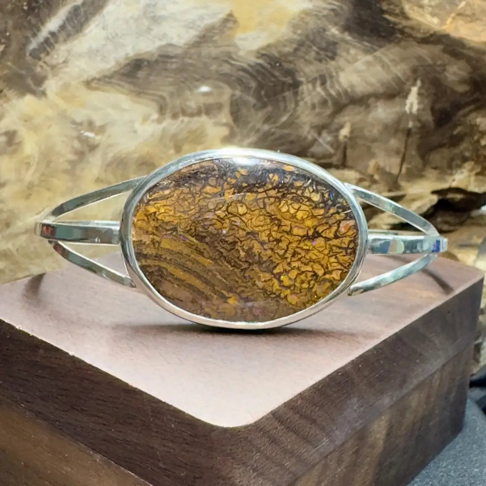 Silver bracelet with brown and yellow stone.