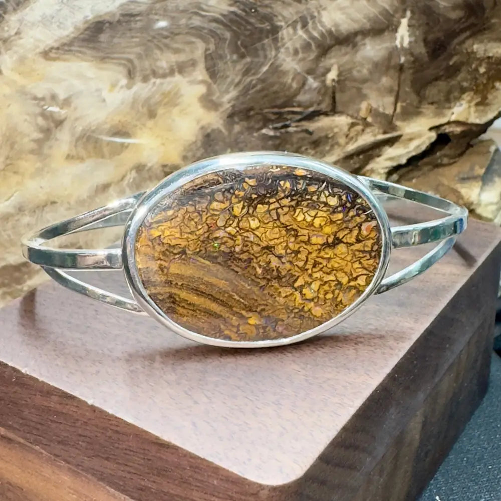 Silver bracelet with brown and yellow stone.