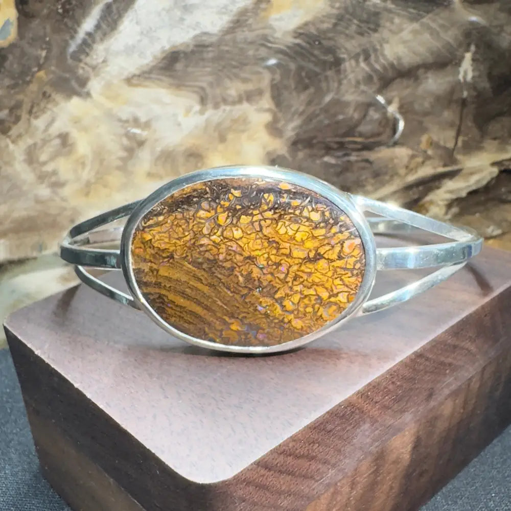 Silver bracelet with oval, patterned stone.