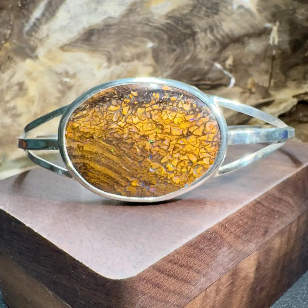 Silver bracelet with cracked amber stone.