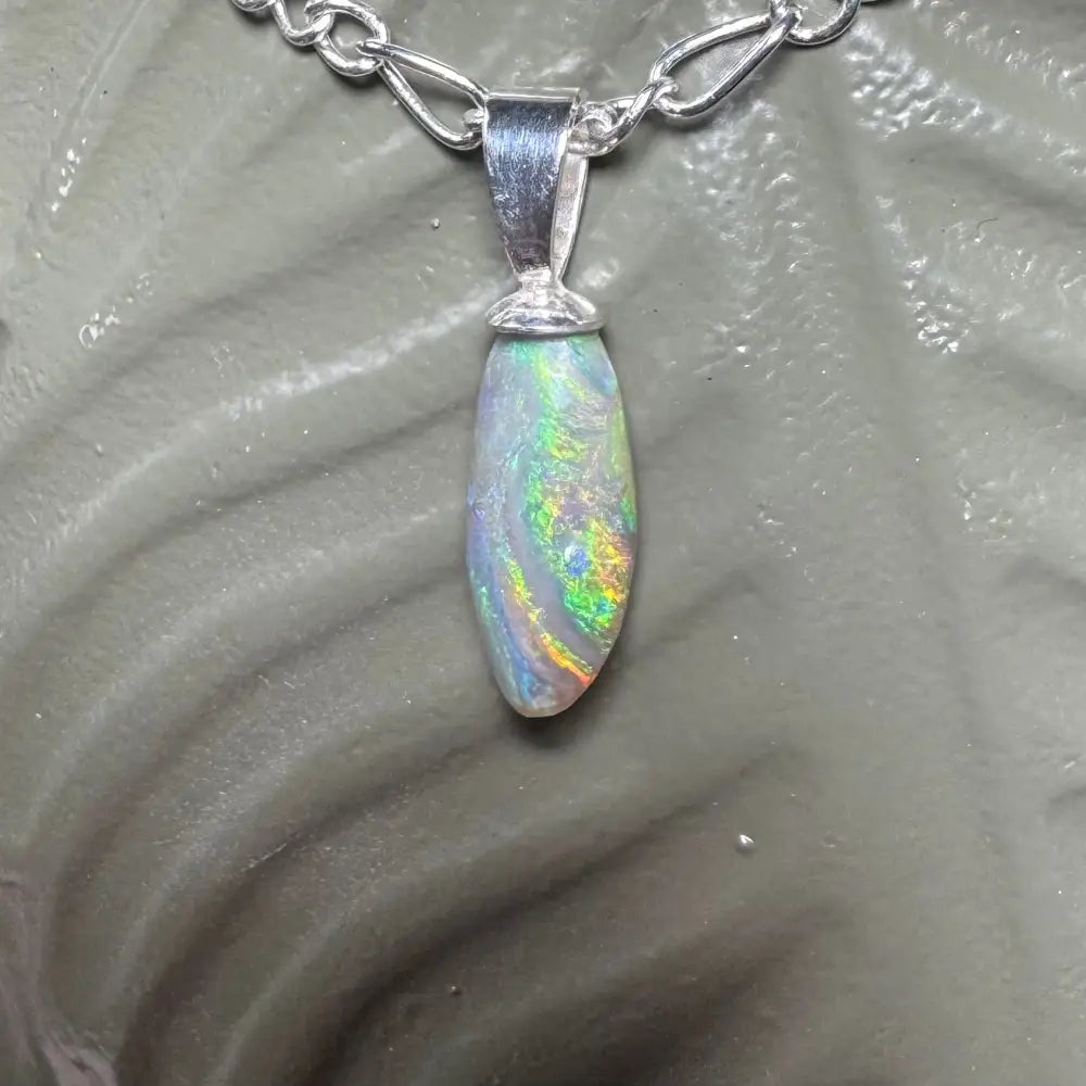 Opal pendant with silver chain in Eucalyptus Whisper handcrafted jewelry display