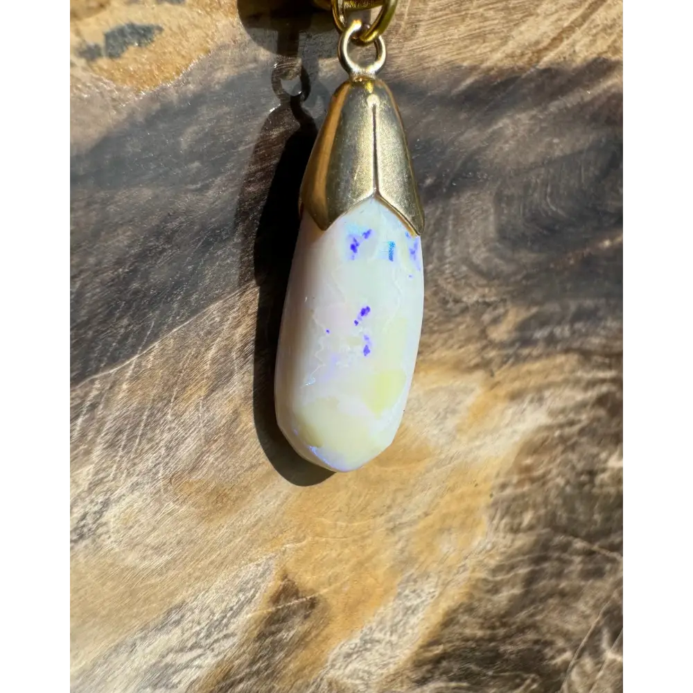 Golden Horizons handcrafted 9ct gold pendant with lightning ridge white opal and gold cap