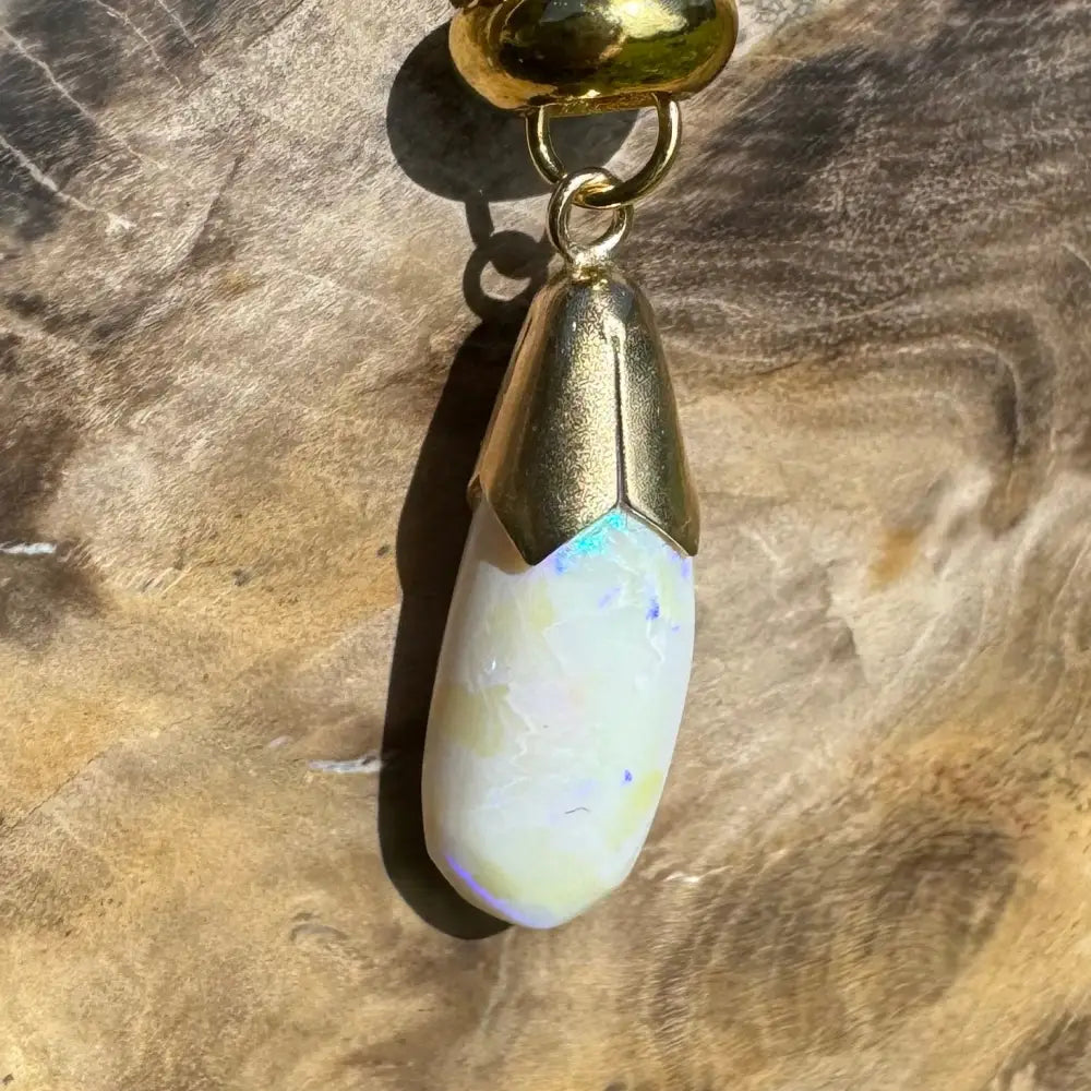 Gold-capped opal pendant from Golden Horizons handcrafted 9ct solid gold with lightning ridge white opal